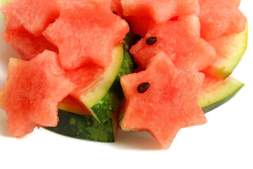 Watermelon pieces cut into a star shape lie on a white background.	