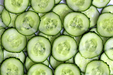 Texture of sliced cucumbers stacked on top of each other.	