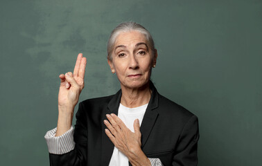  looking happy, confident and trustworthy, smiling and showing victory sign, with a positive...