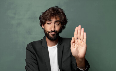  looking serious, stern, displeased and angry showing open palm making stop gesture