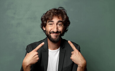  smiling confidently pointing to own broad smile, positive, relaxed, satisfied attitude