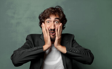  looking excited and surprised, open-mouthed with both hands on head, feeling like a lucky winner