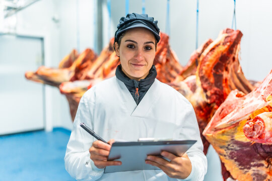 Portrait of a woman working in a meat processing factory