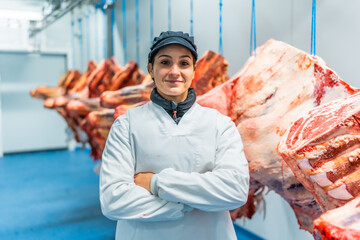 Portrait of a woman standing proud in a meat factory