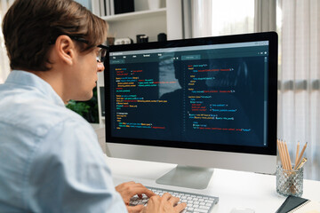IT developer working online software development information on pc and laptop screen with typing to create new code program on updated version application project creating overall system. Pecuniary.