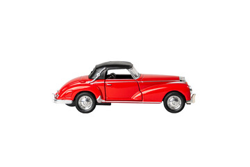 A red car with a black top is parked on a white background. The car is a classic model and has a vintage feel to it. The red color of the car stands out against the white background