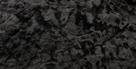 Empty black grain stone wall on cave for abstract  background and texture. beautiful patterns, space for work, banner,seamless wallpaper, close up.
