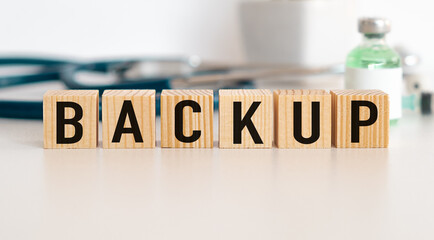 Backup Word Written In Wooden Cube on office Background