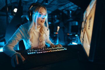 Young woman engaged in competitive gaming in a modern setup