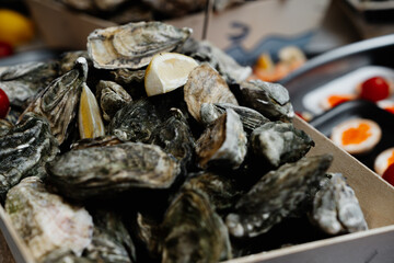 Fresh oysters with lemon served at a seafood market in the afternoon