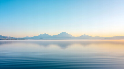 Obraz premium Gentle ripples of graceful water flow at sunrise on a calm lake creating a tranquil landscape experience