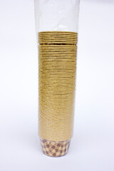 Cupcake muffin cases pack isolated on white background, front view. Brown checkered pattern greaseproof paper baking cups.