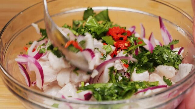 Cooking fish Peruvian ceviche close-up. Fresh cooked ceviche made of raw white fish. Traditional Peruvian cuisine. Cooking seafood dish.