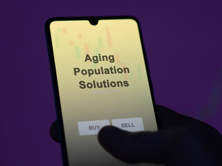 An investor analyzing the aging population solutions etf fund on a screen. A phone shows the prices of Aging Population Solutions