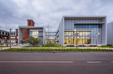 Modern hospital architecture with glass facade at dusk