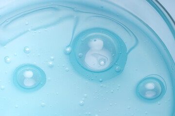Transparent bubbles in blue liquid texture with abstract design
