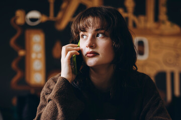 Young woman engaged in a phone conversation indoors