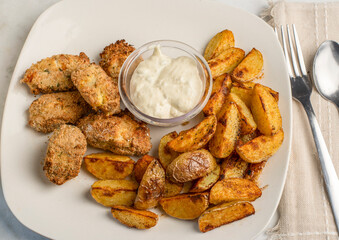 fish nuggets  with  potato wedges and tarter sauce