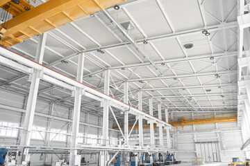 Bridge cranes inside hangar. Overhead cranes inside industrial building