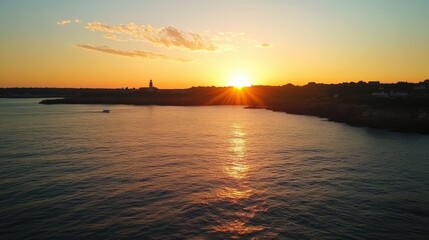 Naklejka premium Newport Twilight: Castle Hill Lighthouse, Rhode Island Silhouetted Against Stunning Sunset Sky
