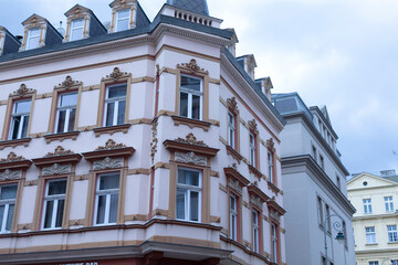 There is a striking white building that boasts a gray roof and features an impressive number of windows that allow natural light inside