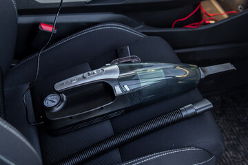 Car vacuum cleaner on car seat. Natural