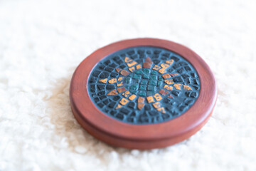 A handcrafted stone mosaic in rich colors, featuring a traditional design. The natural materials and vibrant tones make this piece a striking example of artistic craftsmanship