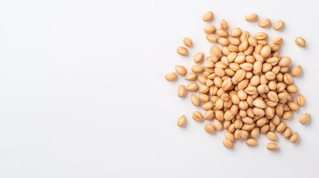 A close-up view of raw yellow lentils scattered on a white surface, showcasing their smooth texture and natural color, perfect for culinary uses.
