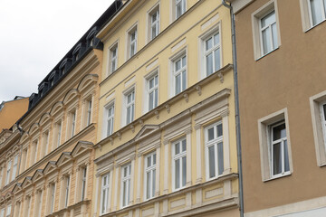 A large, multistory building featuring numerous windows throughout its design, creating an inviting facade and allowing ample light inside
