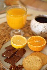 Pumpkins, various food and drinks, fall decorations, books and candles on the table. Fall hygge at home. Selective focus.