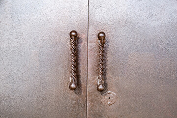 curly handles on painted metal gates