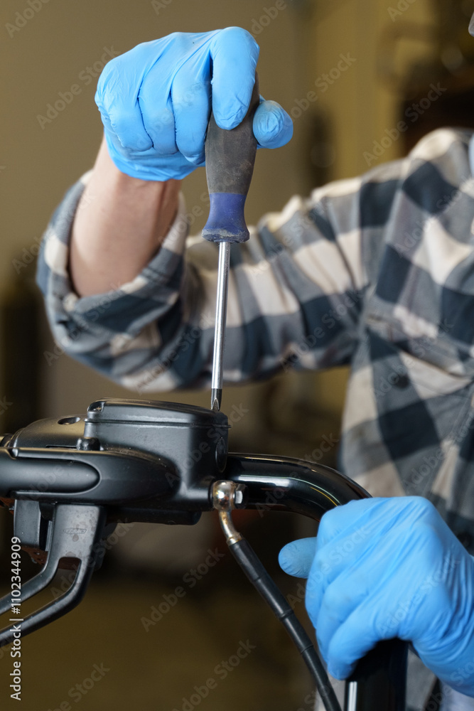 Poster A technician repairs a device using a screwdriver in a workshop setting
