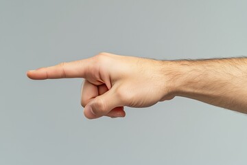 Side view of a hand pointing forward on a plain gray background