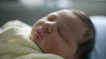 Newborn baby sleeping peacefully in a cozy white outfit, showing a serene and relaxed expression....