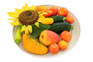Tomatoes, onions, sunflower, pear and zucchini in a rustic ceramic plate isolate on white background. Variety vegetables in rural bowl.