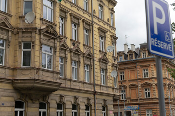 There is a building prominently displaying a parking sign that clearly states reserved right in front of it, indicating special access