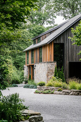 An architectural photograph of an exterior view from the driveway, showcasing how greenery and native plants surround a modern barn house with dark wood accents and stone walls.