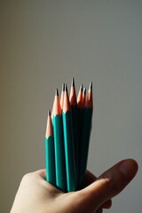 Green set of graphite pencils in hand