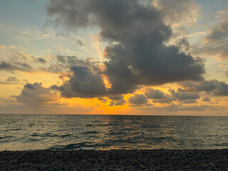 the sea wave rolls over the colorful pebbles on the Black Sea coast