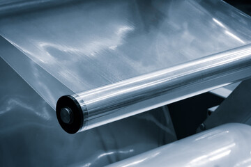 Automatic polyethylene plastic bag production machine with lighting effect. Close-up of the roller...