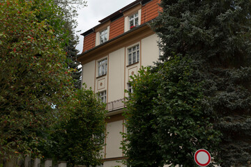 In front of a large, imposing building, there is a prominent no entry sign that clearly indicates restricted access to its premises