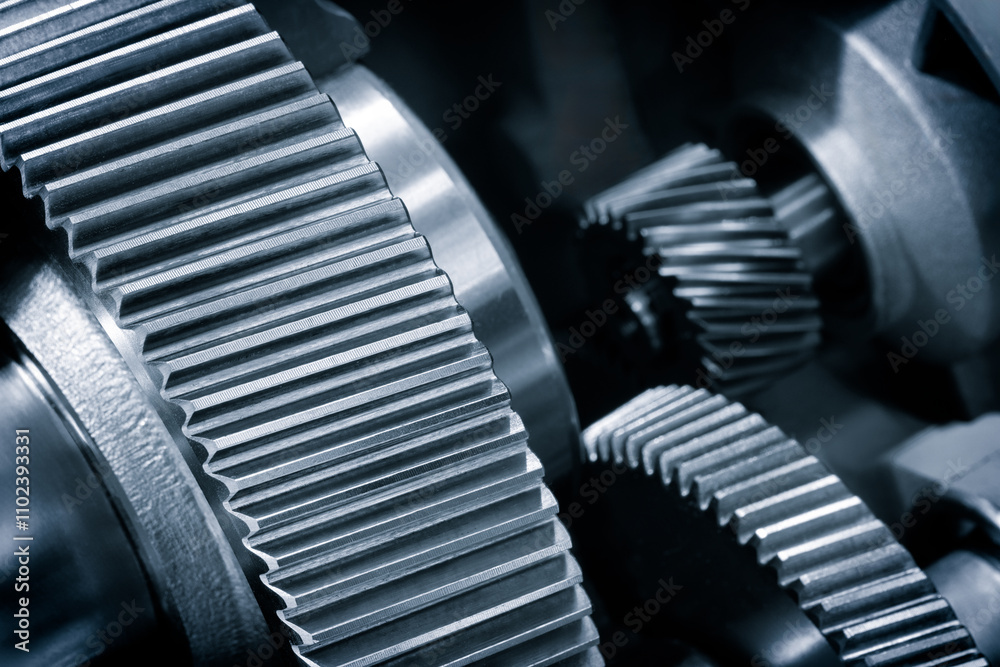 Poster a close up of a gear with many teeth. the gear is part of a machine and is made of metal in blue