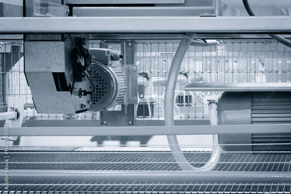 Poster A machine with a motor and a fan. The fan is on the left side of the machine