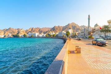 Fototapeta premium The Mutrah Corniche waterfront park and promenade along the Gulf of Oman, Arabian Sea, at Al Bahri road, with the Masjid Al Rasool Al A'dham Mosque and Minaret in view