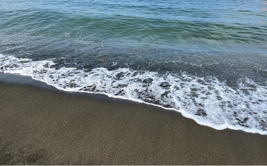 the sea wave rolls over the colorful pebbles on the Black Sea coast