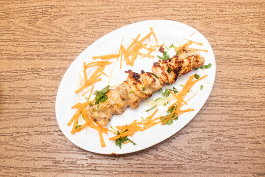 chicken reshmi kabab or malai tikka served in tray dish isolated on wooden table top view of bangladeshi food