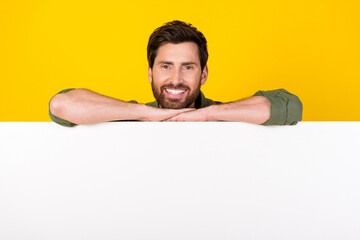 Photo of nice young man empty space ad wear shirt isolated on yellow color background