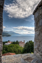 Naklejka premium Castle walls, view of Samuil's Fortress, Unesco World Heritage Site, on Lake Ohrid, Ohrid town. View from watchtower of famous old fortress ruins of king Samuel. Clouds over the Lake and blue water.