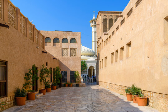 Alley view looking towards the wind tower and minaret in the Al Bastakiya Al Fahidi Cultural and Historical District, near Dubai Creek in Dubai, United Arab Emirates.	
