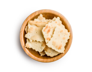 A crispy salted crackers in bowl isolated on white background.